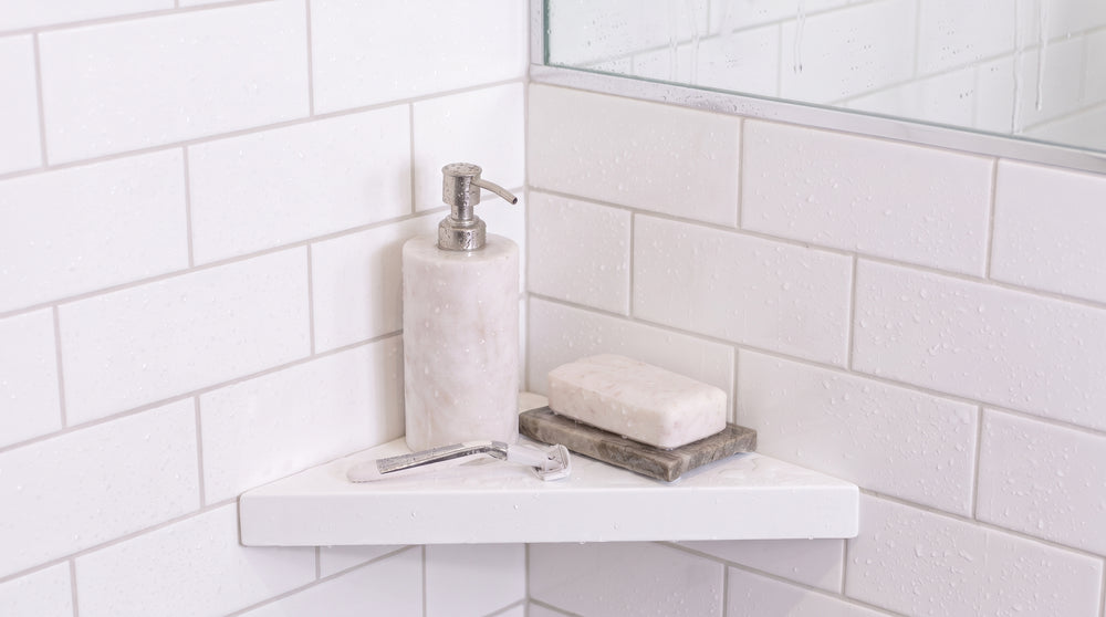 White shower shelf holding soap in a bathroom